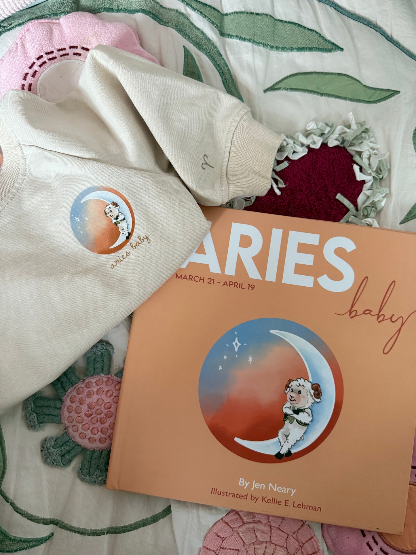 Beige Cancer zodiac crewneck sweatshirt for toddlers and babies and Aries zodiac baby book