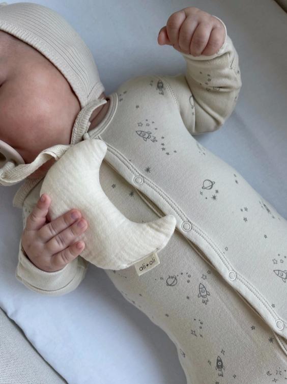 baby holding moon pacifier holder