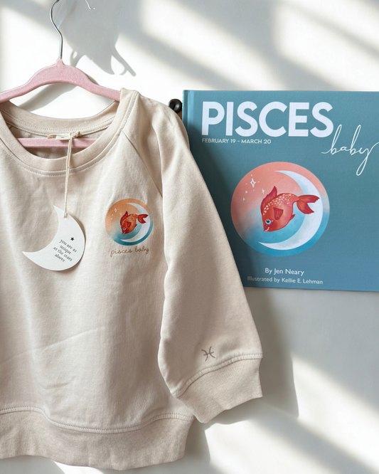 pisces toddler crewneck with fish on it paired with the zodiac baby book that makes a thoughtful and meaningful baby shower gift bundle