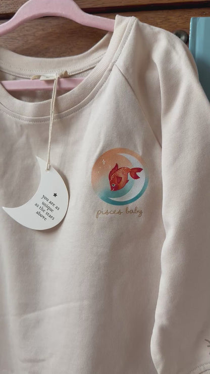 pisces toddler crewneck paired with the pisces zodiac baby book