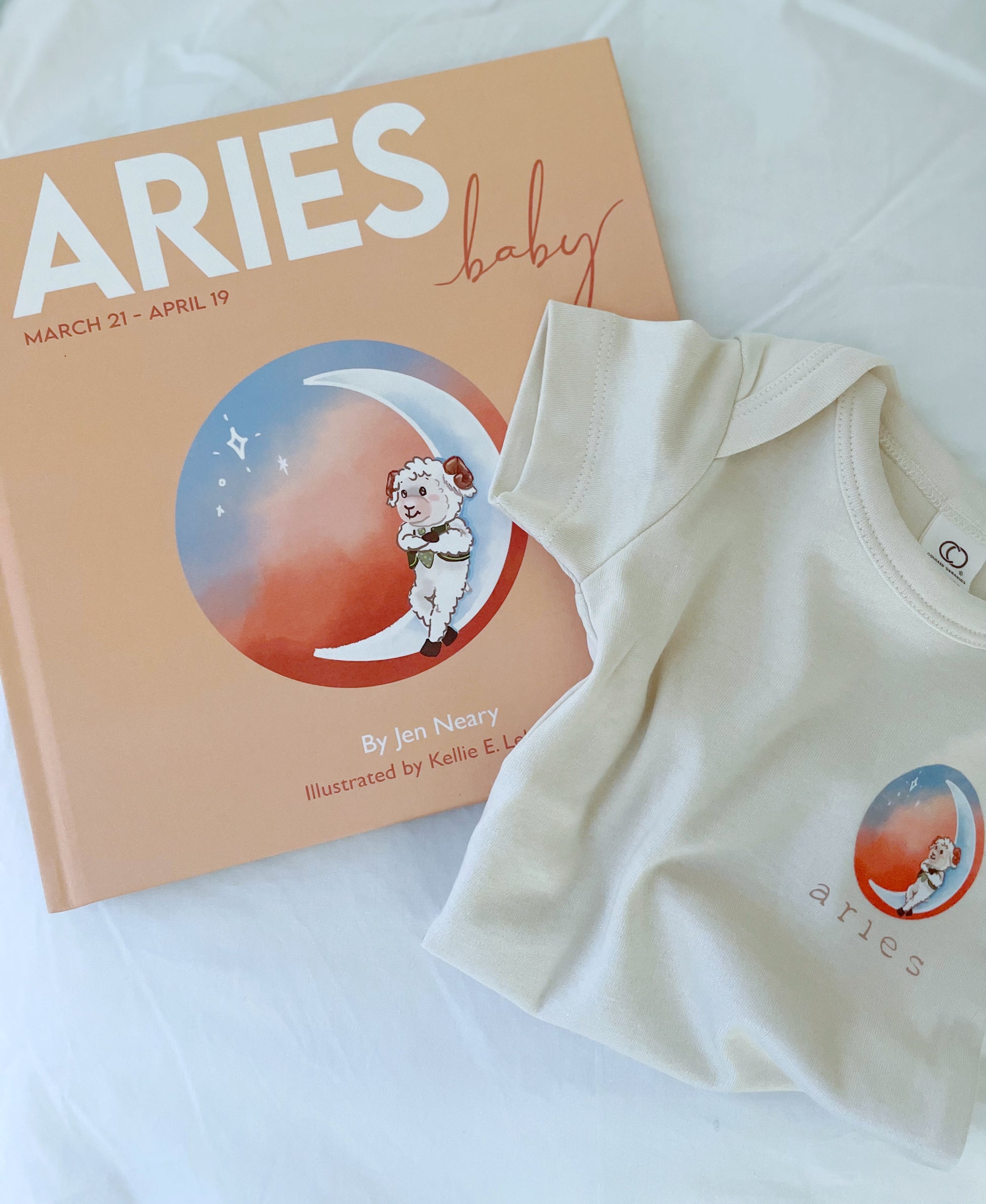 aries zodiac baby book with matching aries zodiac baby onesie.