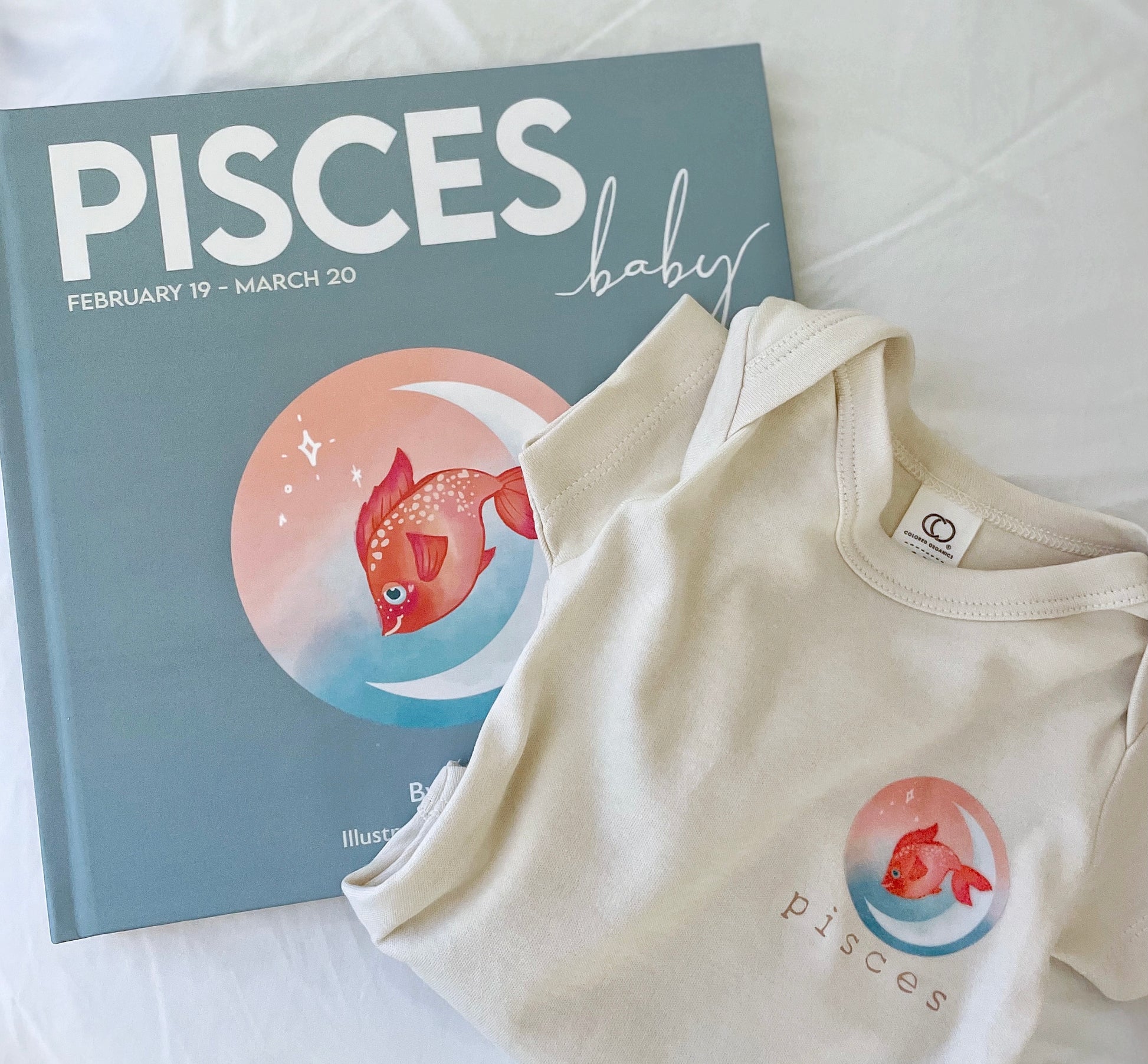 pisces zodiac baby book and its matching zodiac baby onesie.